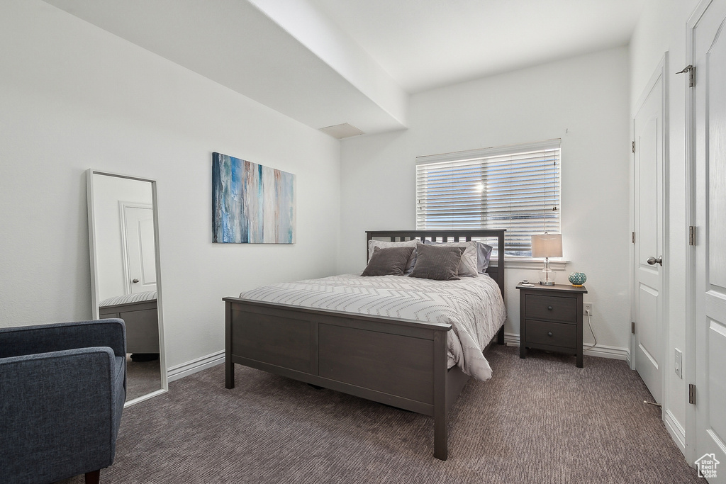 Bedroom with baseboards and carpet flooring