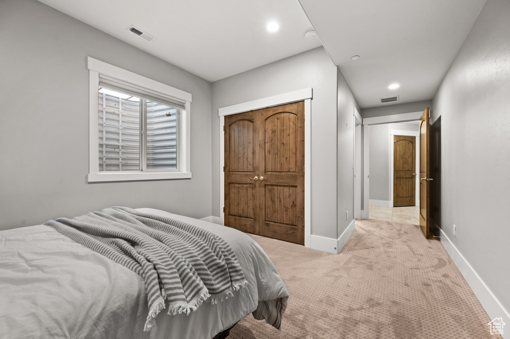 Bedroom with recessed lighting, visible vents, light colored carpet, and baseboards