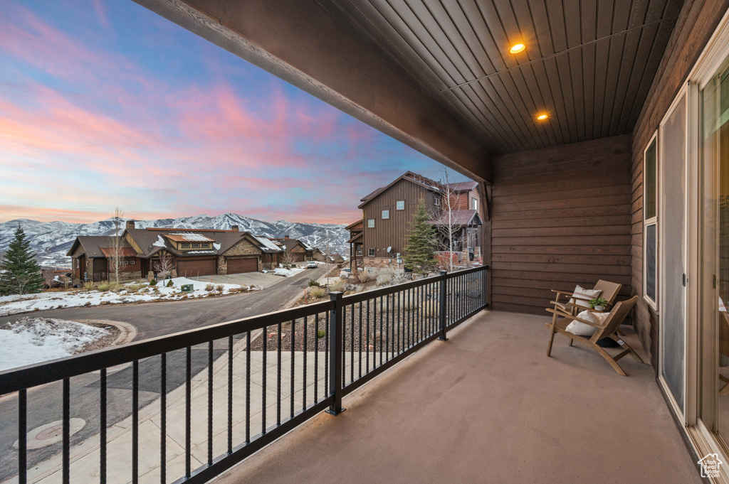 Snow covered back of property with a mountain view