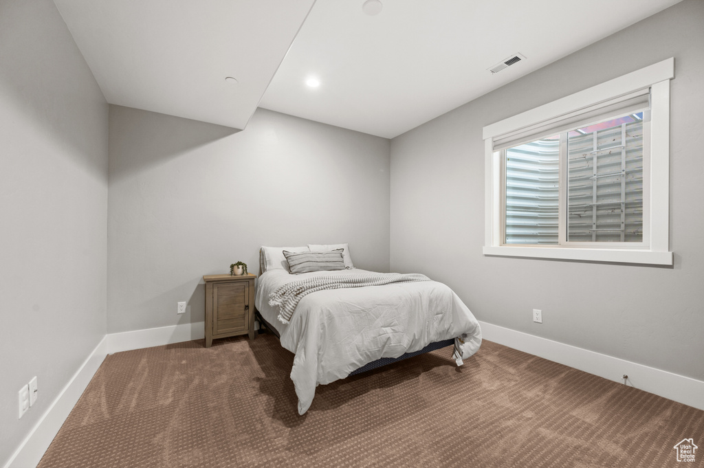 Bedroom with visible vents, baseboards, and carpet flooring