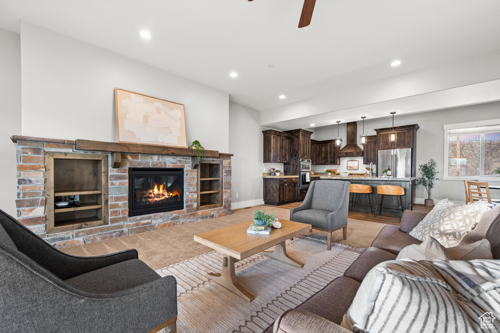 Living area with a fireplace, recessed lighting, baseboards, and ceiling fan