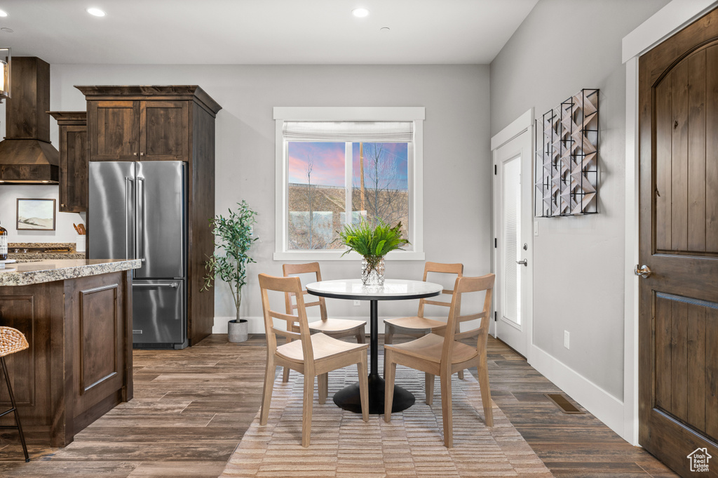 Dining room featuring dark wood-type flooring, recessed lighting, and baseboards