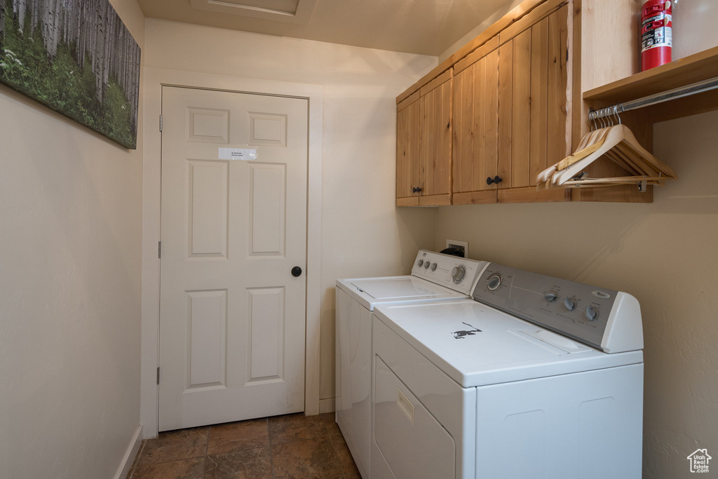 Laundry room with cabinet space, attic access, separate washer and dryer, and baseboards