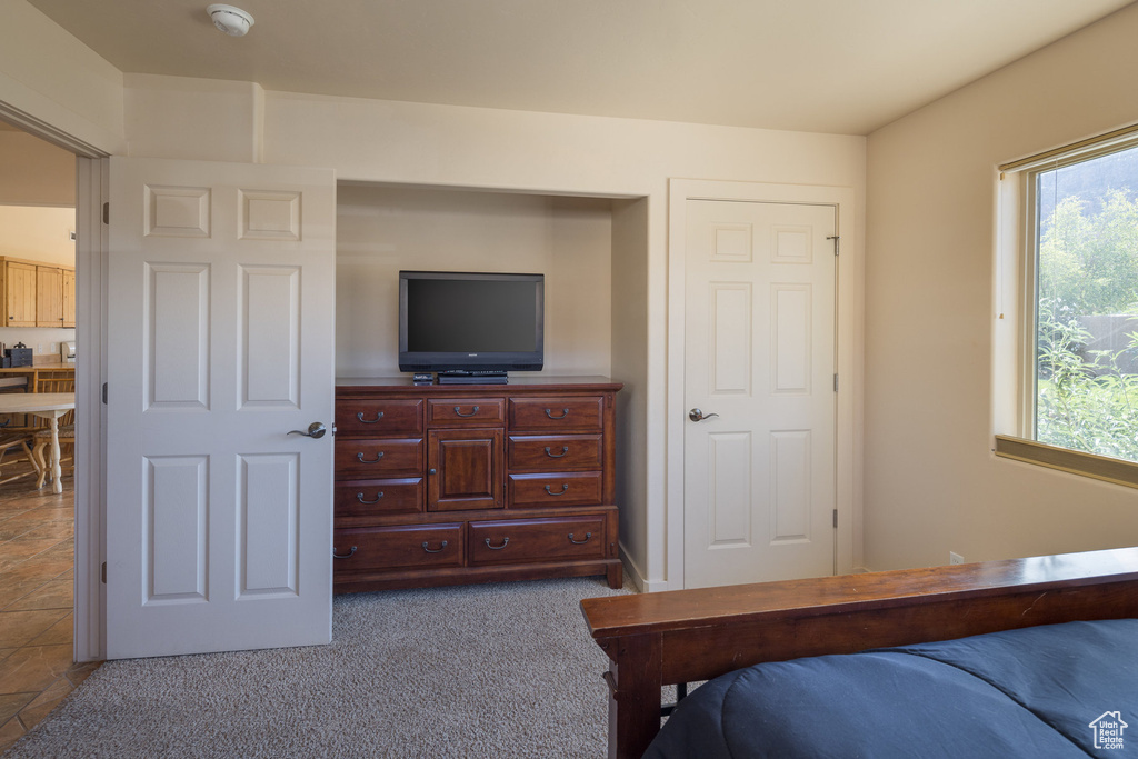 Carpeted bedroom with multiple windows