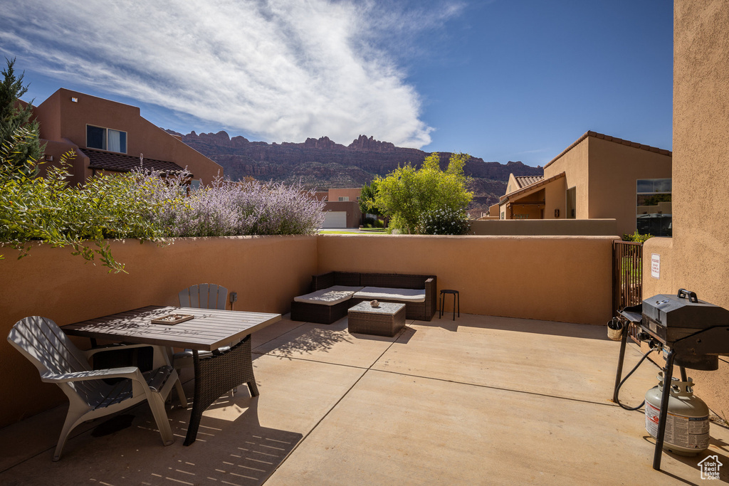 View of patio / terrace with a mountain view, a fire pit, and area for grilling