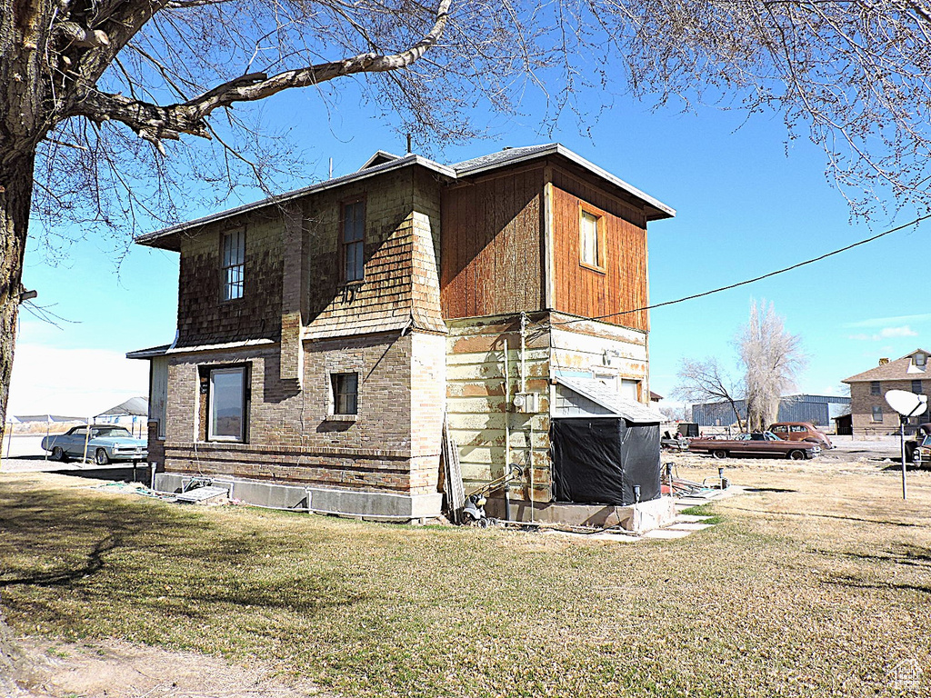 View of property exterior with a lawn