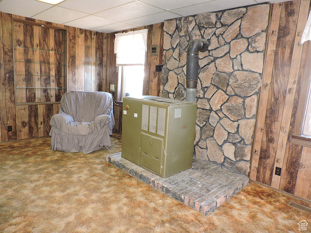 Living area with wooden walls and a drop ceiling