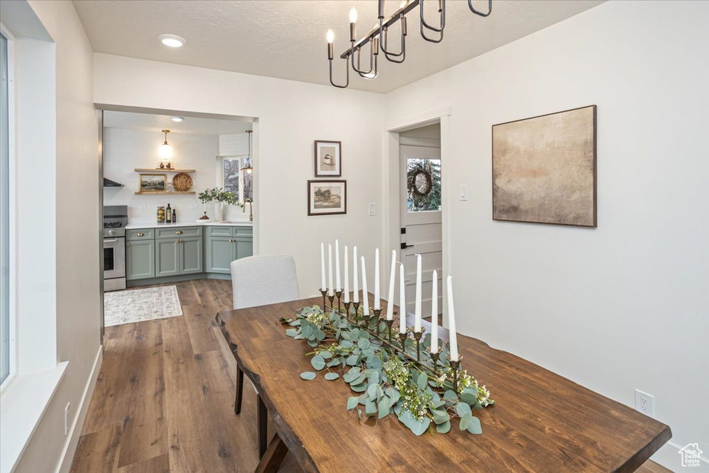 Dining space with dark wood finished floors and a textured ceiling