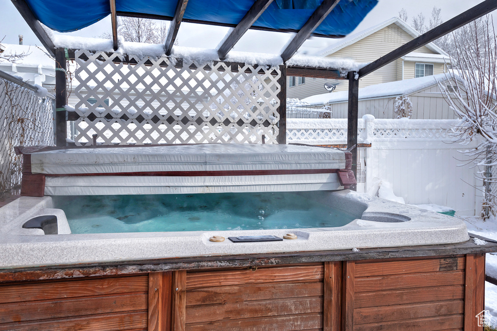 Exterior space featuring a hot tub and fence