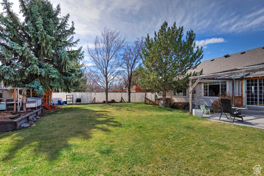 View of yard with a fenced backyard and a patio area