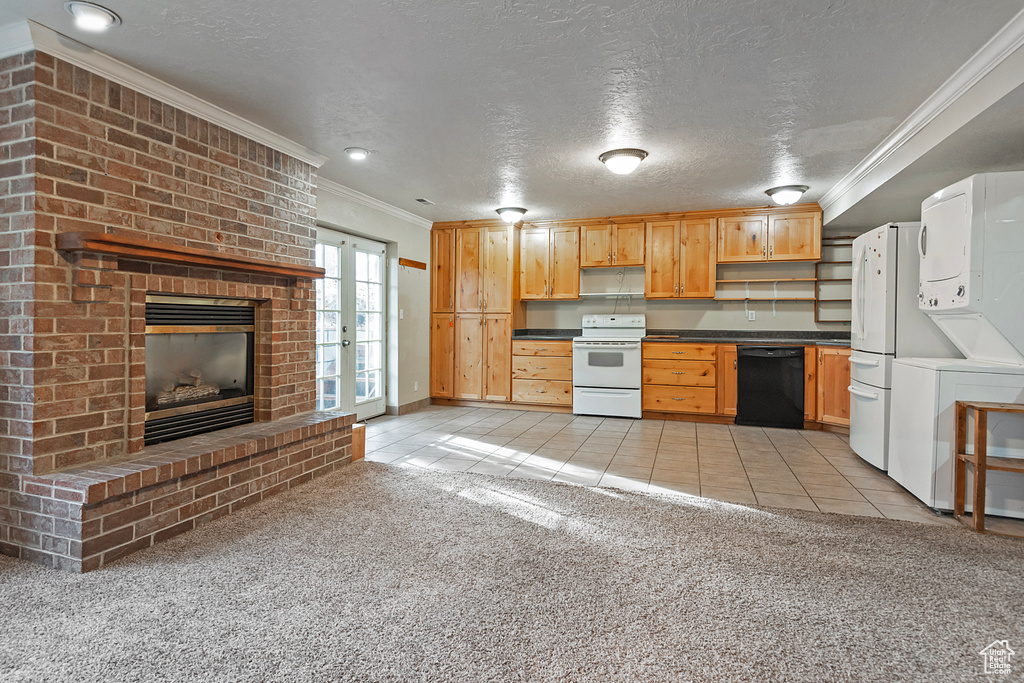 Kitchen with light colored carpet, black dishwasher, stacked washer and dryer, light tile patterned floors, and white electric range