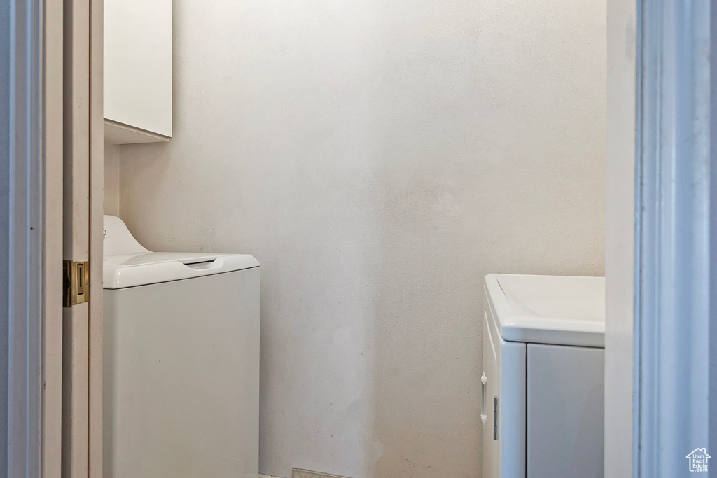 Washroom featuring laundry area and independent washer and dryer