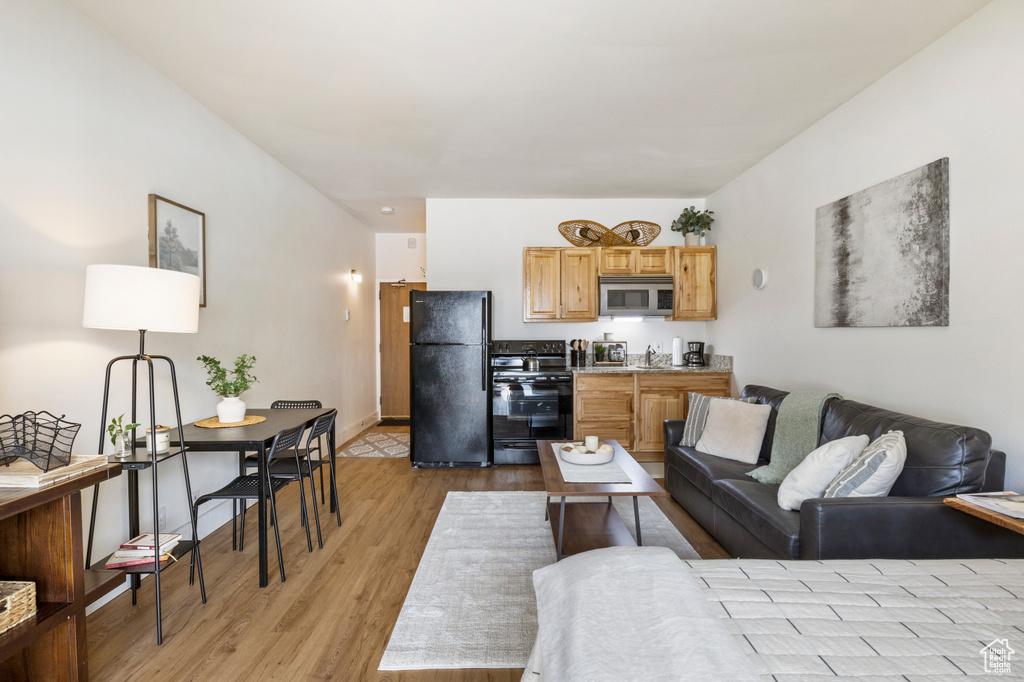 Living room featuring baseboards and light wood finished floors