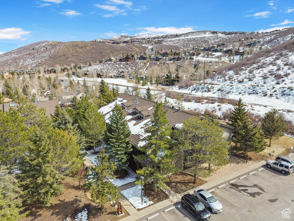 Snowy aerial view featuring a residential view and a mountain view
