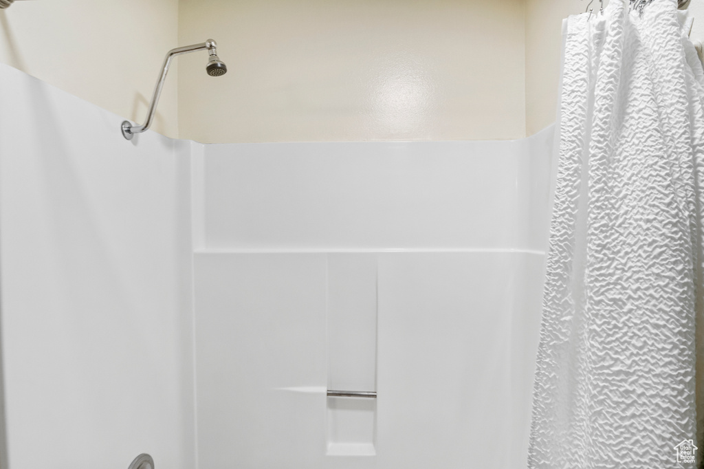 Room details featuring a shower with curtain