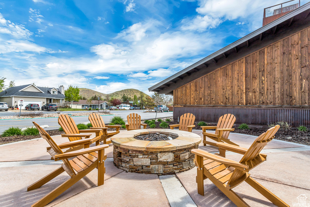 View of patio featuring a fire pit and a mountain view