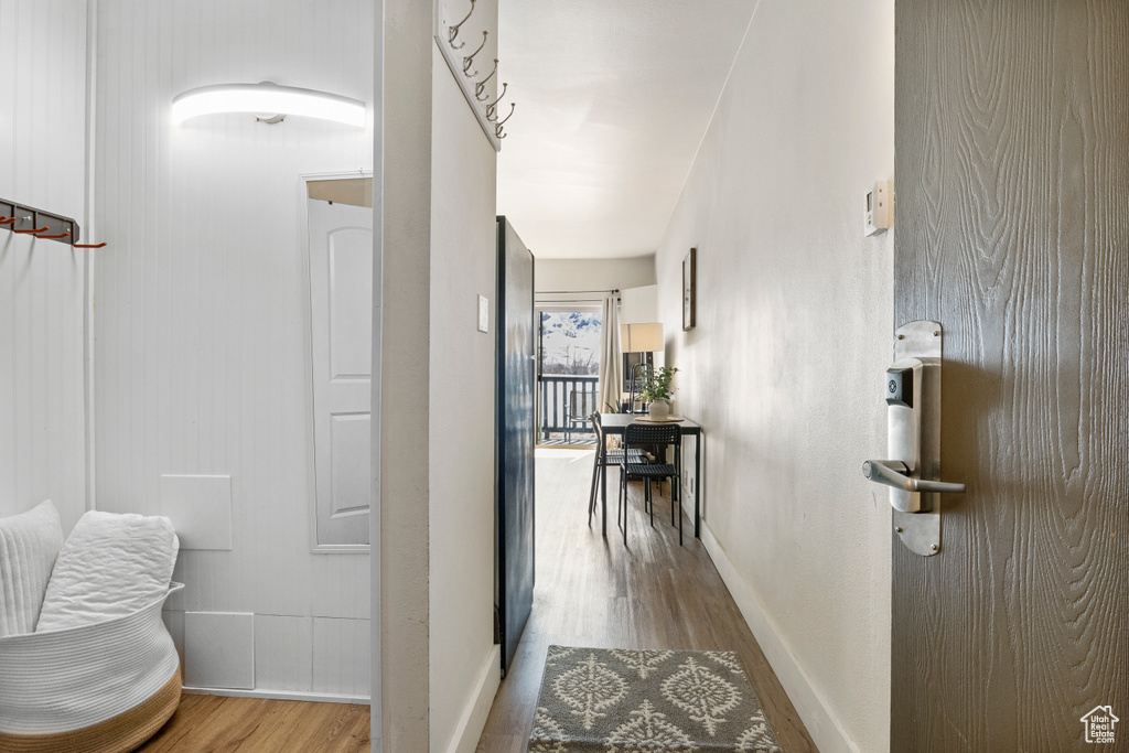Corridor featuring baseboards and wood finished floors