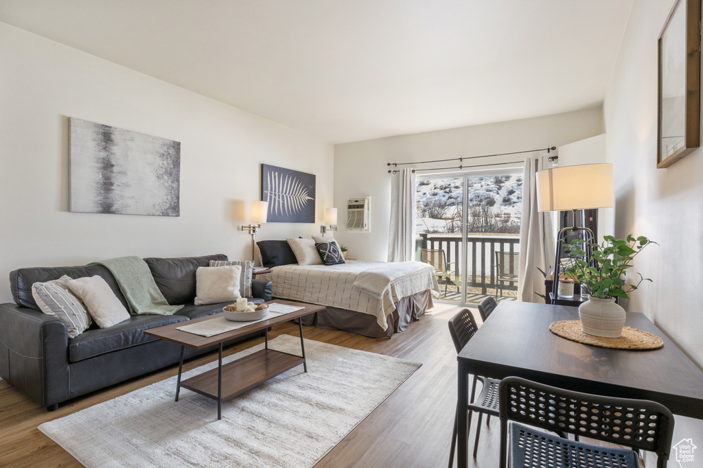 Bedroom with access to outside and wood finished floors