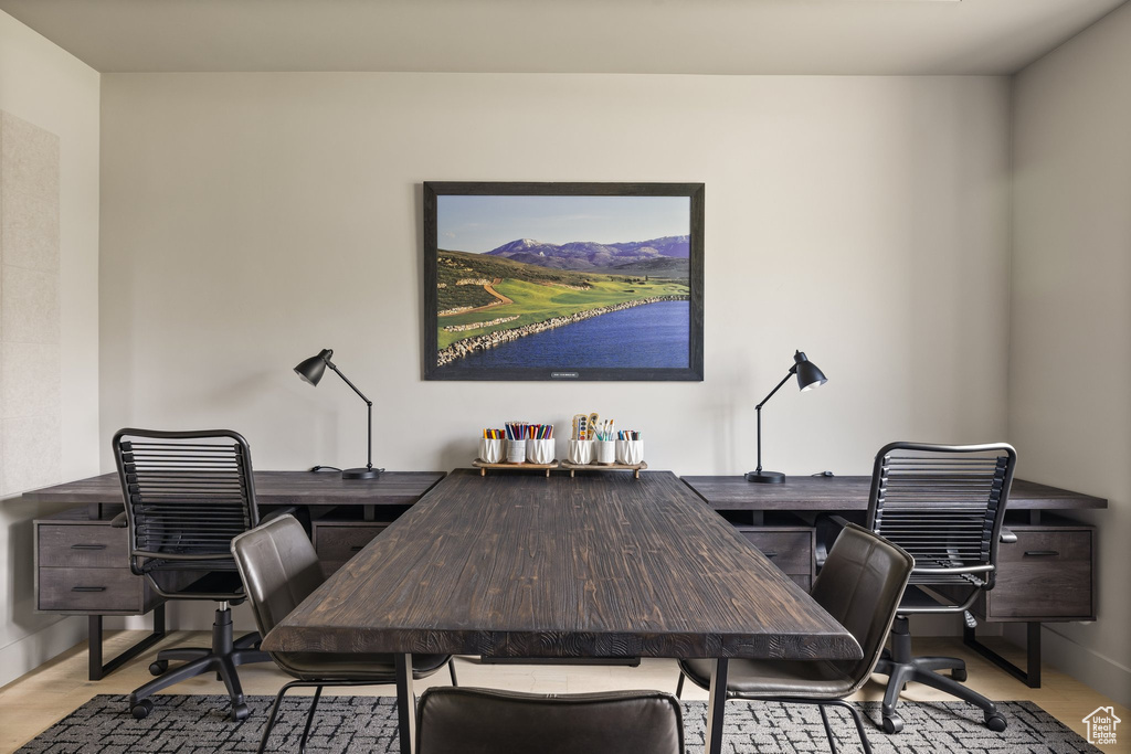 Office with wood finished floors and baseboards