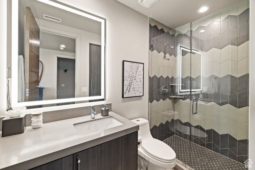 Full bathroom featuring a shower stall, vanity, and recessed lighting