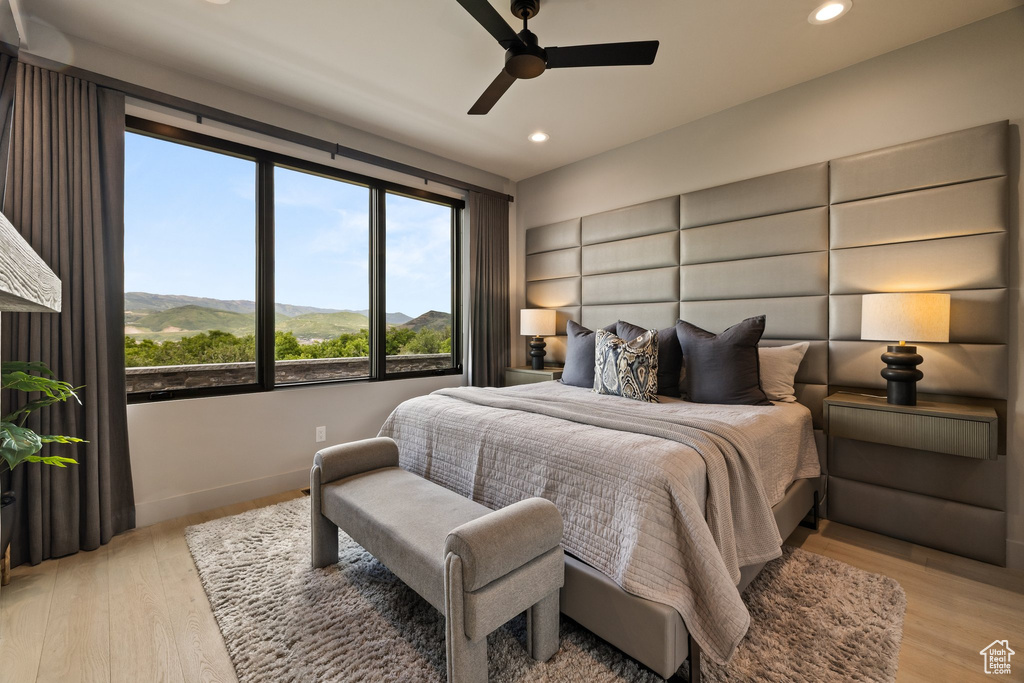 Bedroom with recessed lighting, light wood-type flooring, a mountain view, and a ceiling fan