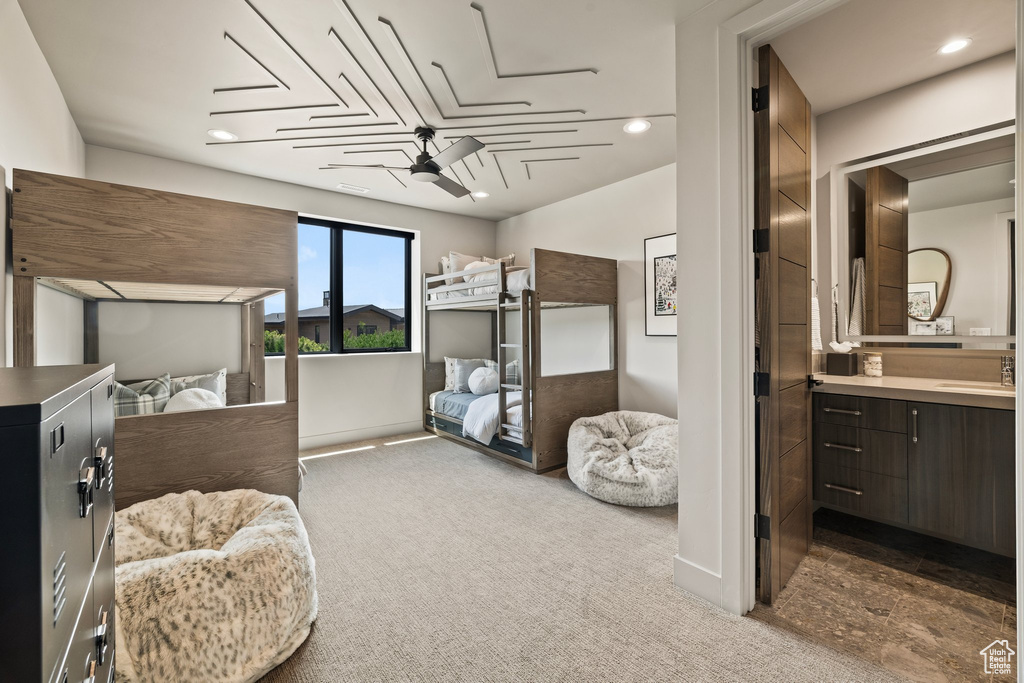 Bedroom featuring carpet, recessed lighting, and ensuite bath