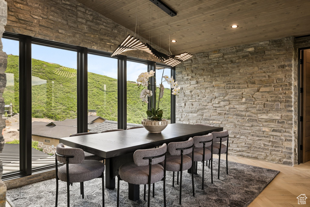 Dining space featuring wood ceiling, a high ceiling, and recessed lighting