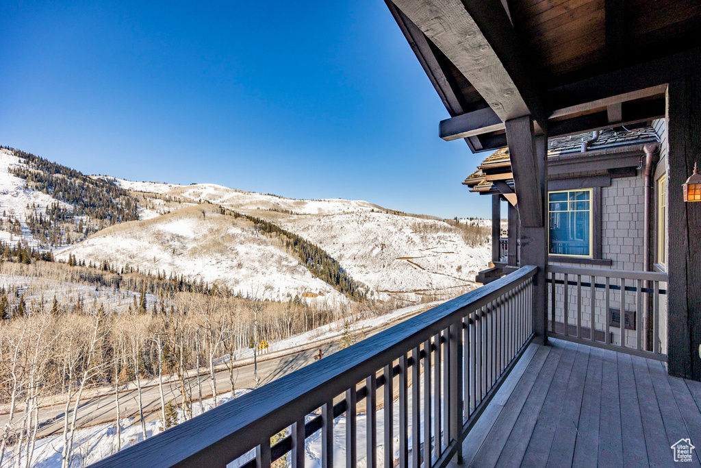 Snow covered back of property with a mountain view