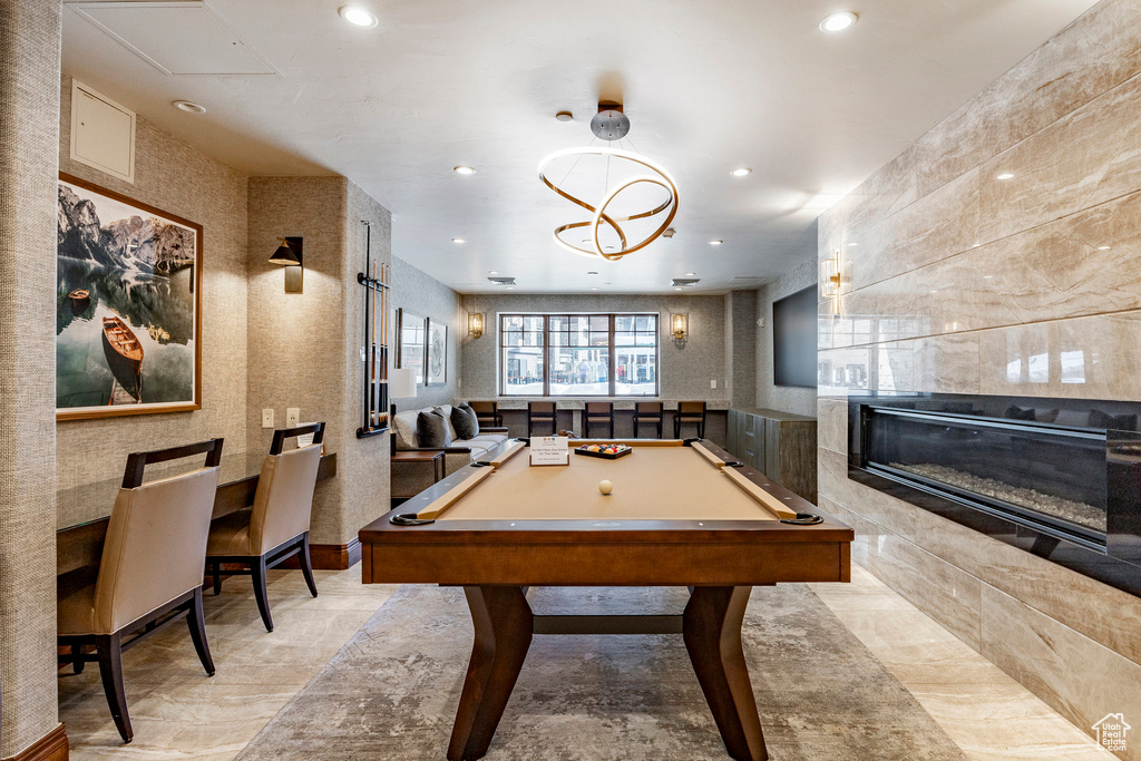 Rec room featuring recessed lighting, pool table, and a tiled fireplace