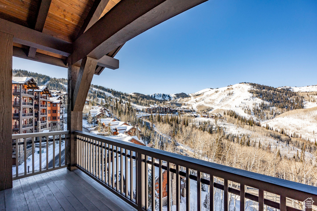 Snow covered back of property featuring a mountain view