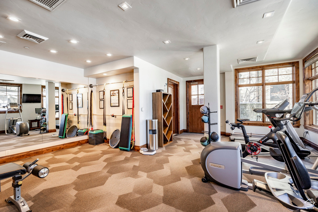 Exercise room with recessed lighting, baseboards, visible vents, and carpet