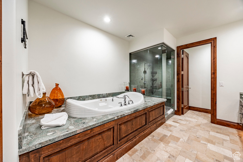 Full bath featuring visible vents, a garden tub, baseboards, recessed lighting, and a stall shower
