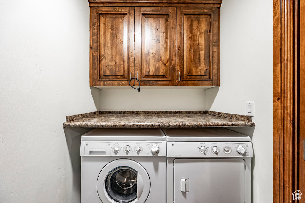 Laundry room featuring cabinet space and independent washer and dryer