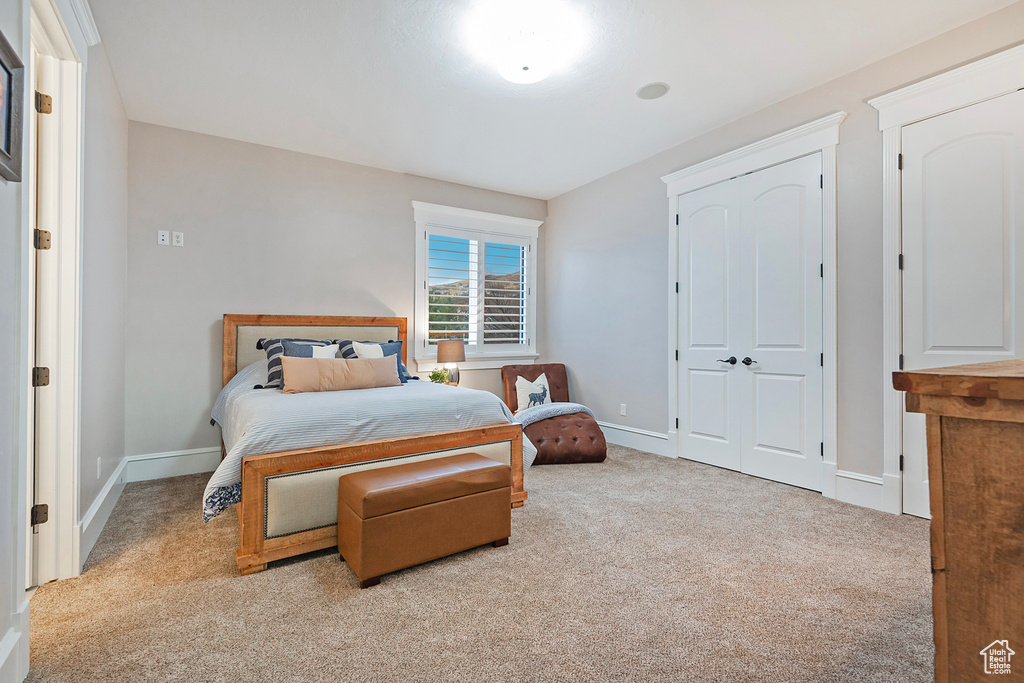 Bedroom featuring carpet floors and baseboards