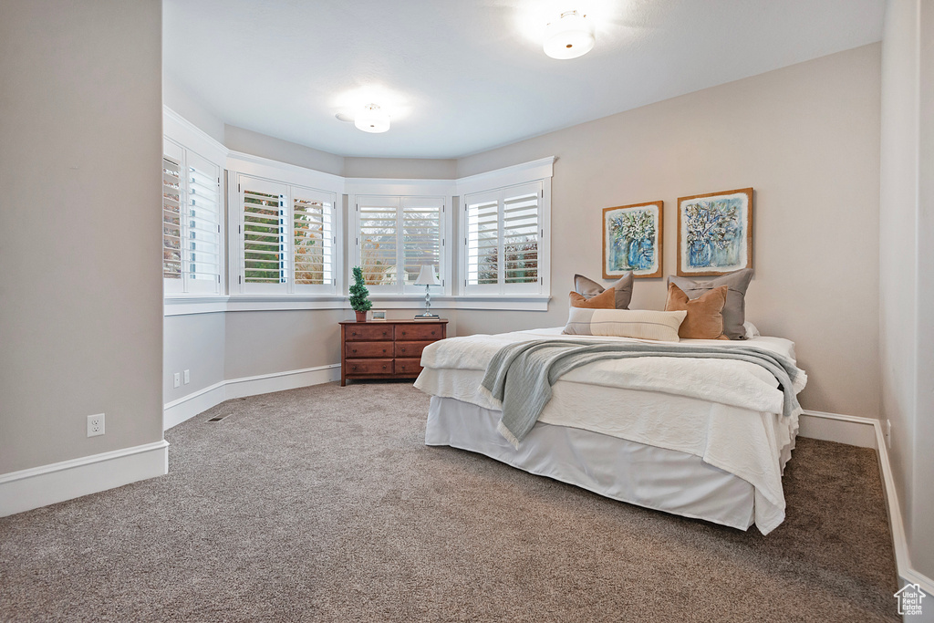 Bedroom featuring carpet floors and baseboards