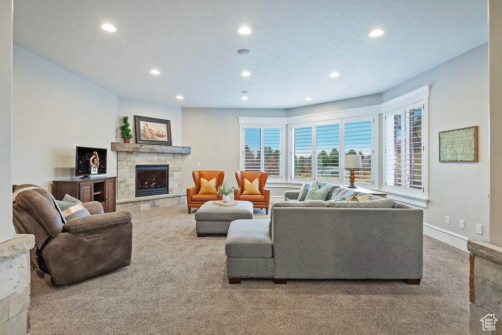 Carpeted living area featuring recessed lighting and a fireplace