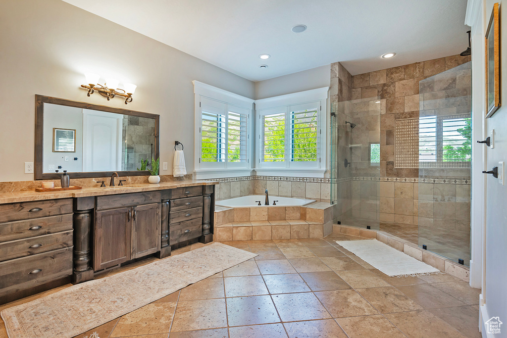Bathroom with plenty of natural light, a bath, a shower stall, and recessed lighting