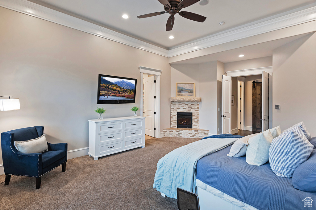 Carpeted bedroom with crown molding, a brick fireplace, baseboards, and recessed lighting