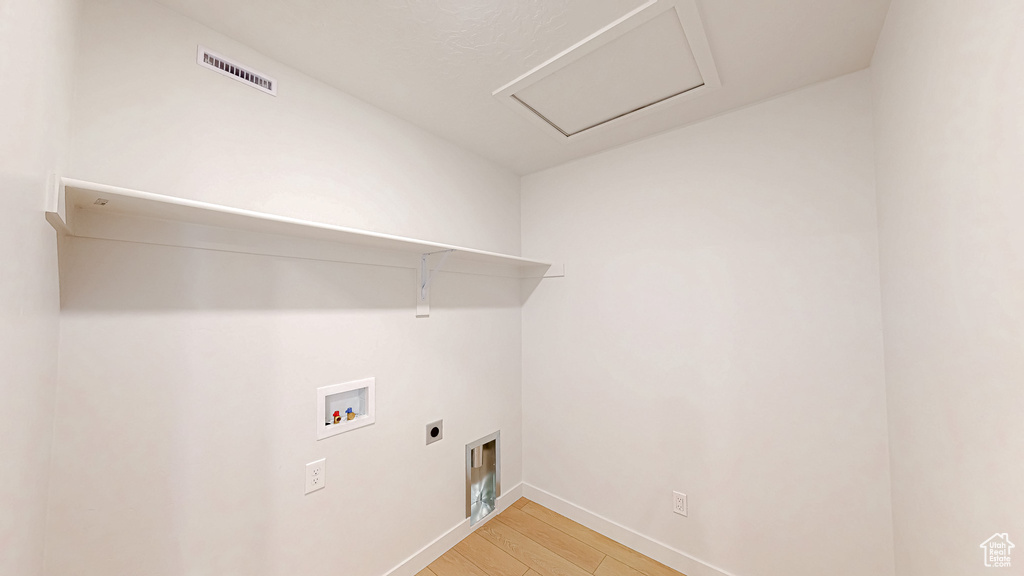 Washroom featuring visible vents, hookup for an electric dryer, laundry area, washer hookup, and light wood-style floors