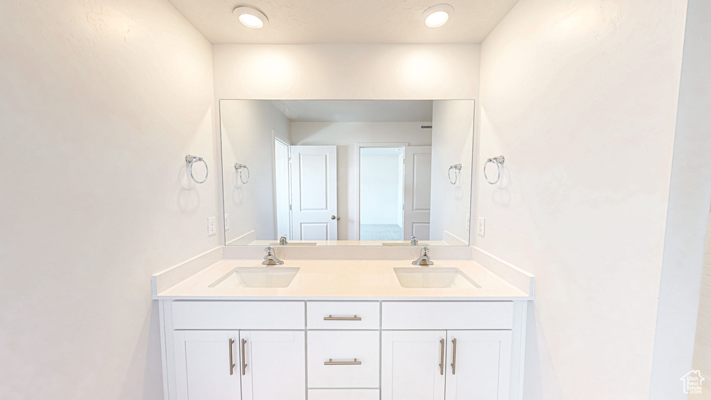 Full bath with double vanity and a sink