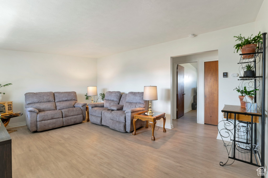 Living room with baseboards and light wood-style floors
