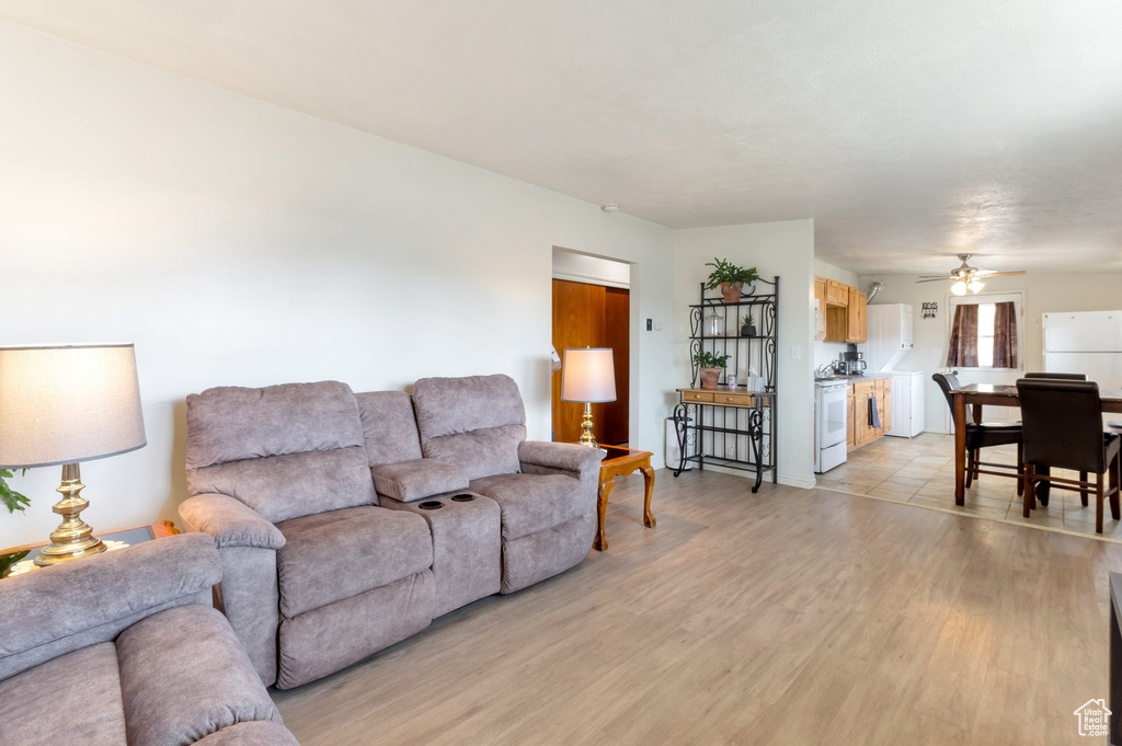 Living room featuring light wood-style floors and ceiling fan