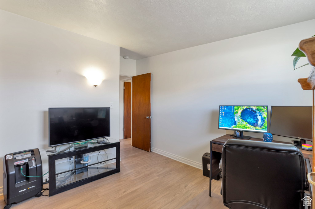 Office space featuring baseboards and wood finished floors