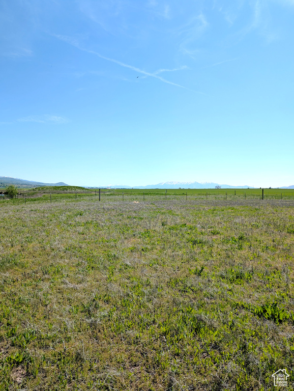 View of yard featuring a view of countryside and a mountain view