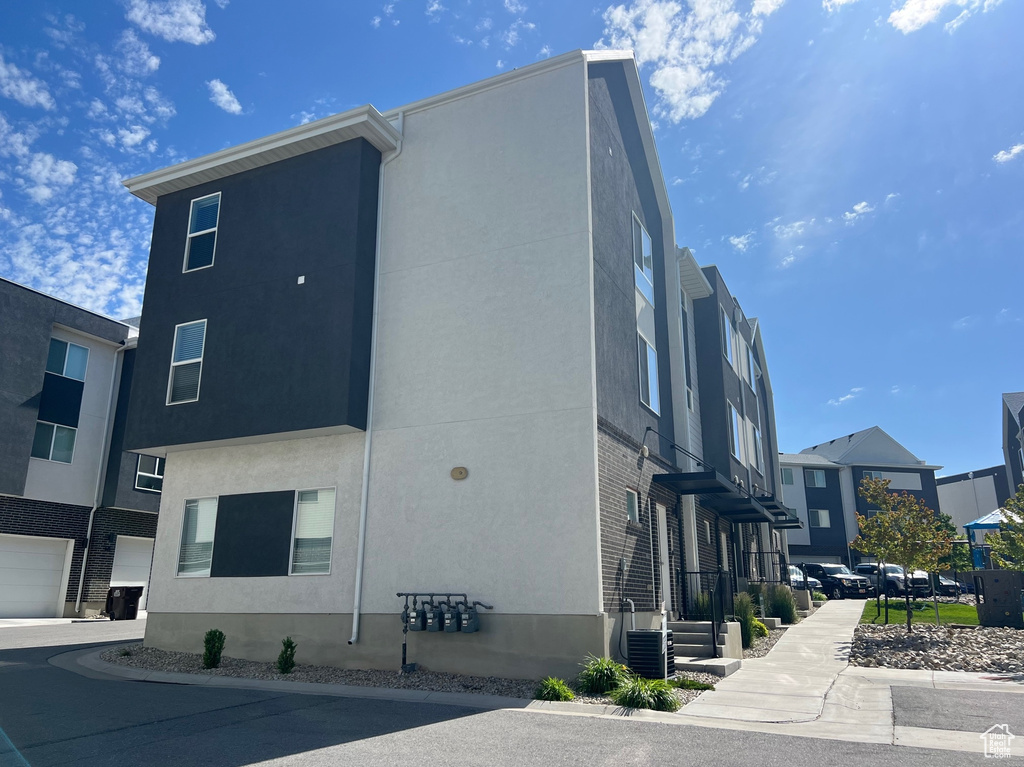 View of property exterior featuring a residential view and stucco siding