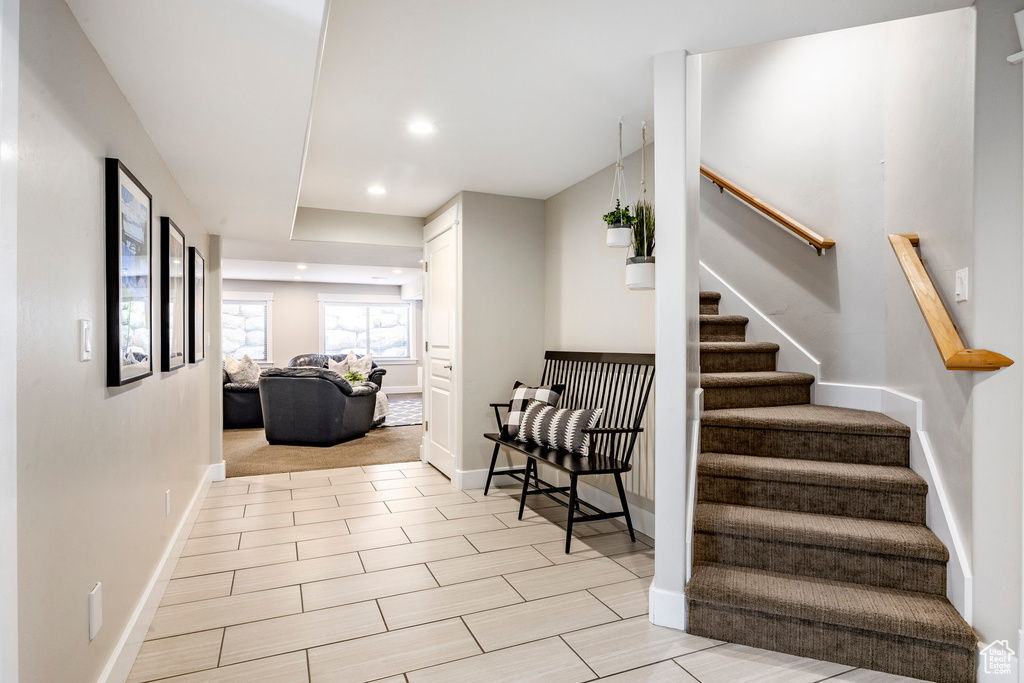 Stairs with baseboards and recessed lighting