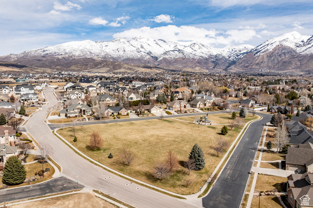 Aerial overview of property's location with nearby suburban area and mountains