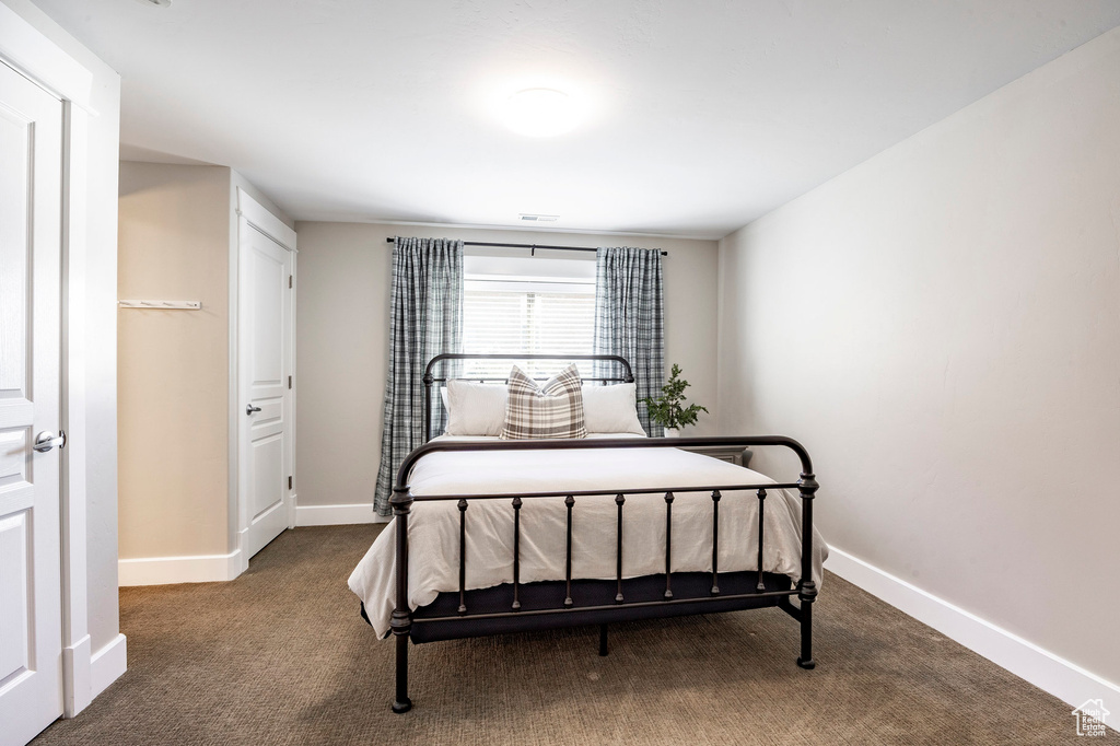 Carpeted bedroom with baseboards
