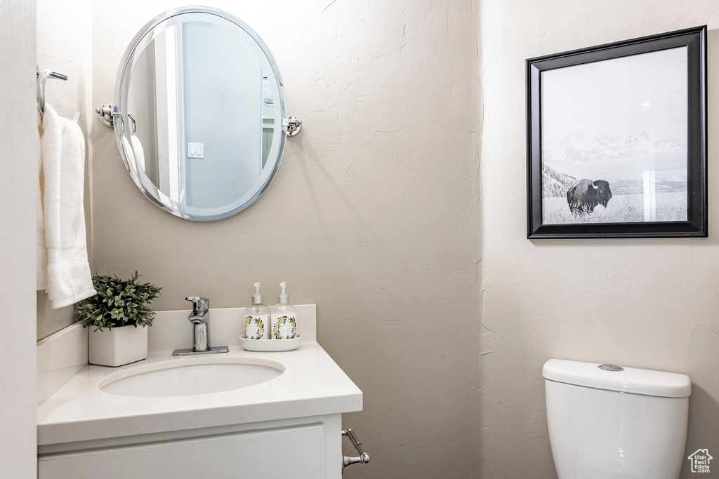 Half bath featuring vanity and toilet