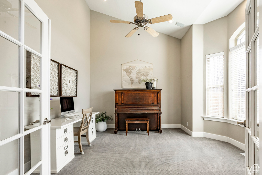 Office area featuring high vaulted ceiling, light colored carpet, plenty of natural light, and ceiling fan